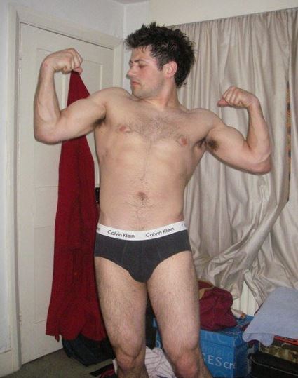 topless man striking a bodybuilding pose
