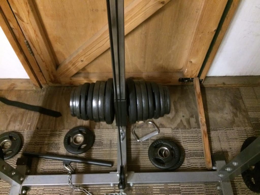squat rack with weights attached to a cable pulley extension system 