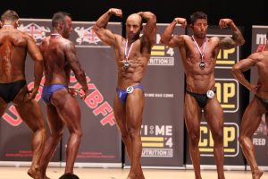 jason james on stage competing in the ukbff 
