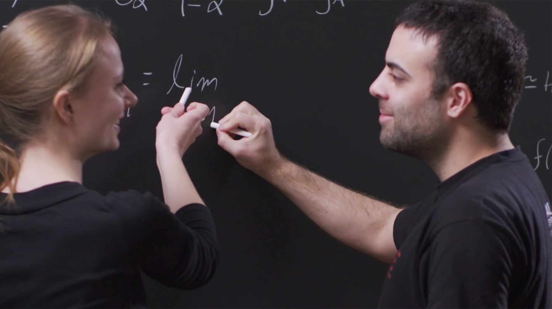 man and woman working out an equation 