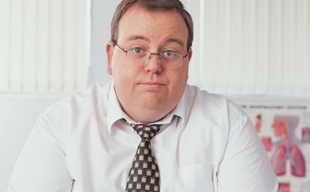 average man in shirt and tie overweight and looking sad