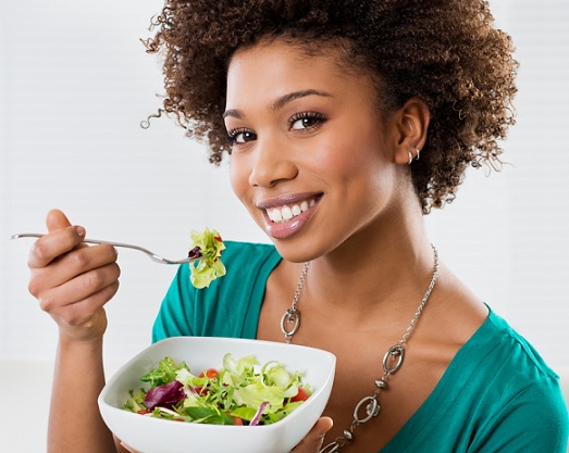 black young woman eating a healthy salad