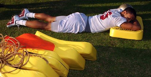 athlete sleeping on tackle pads