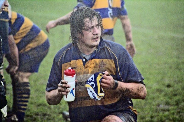 rugby player re-hydrating on the pitch
