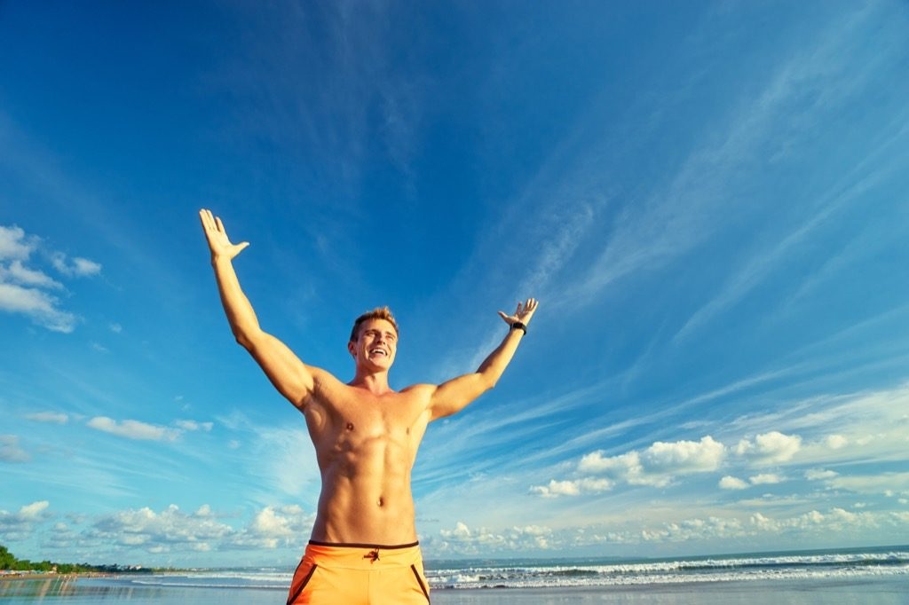 muscular guy basking in sunshine with endless blue skies