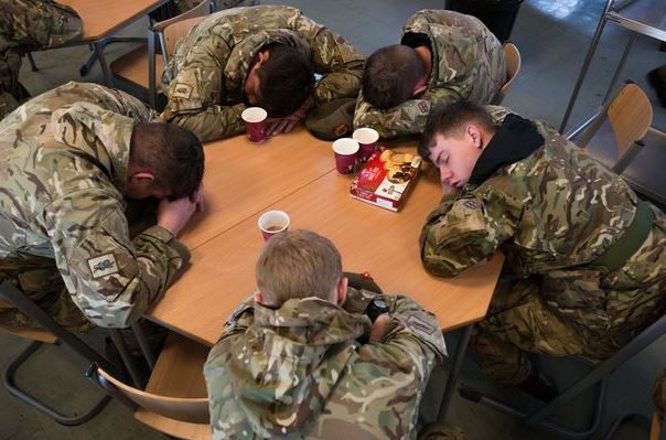 soldiers sleeping at a coffee table