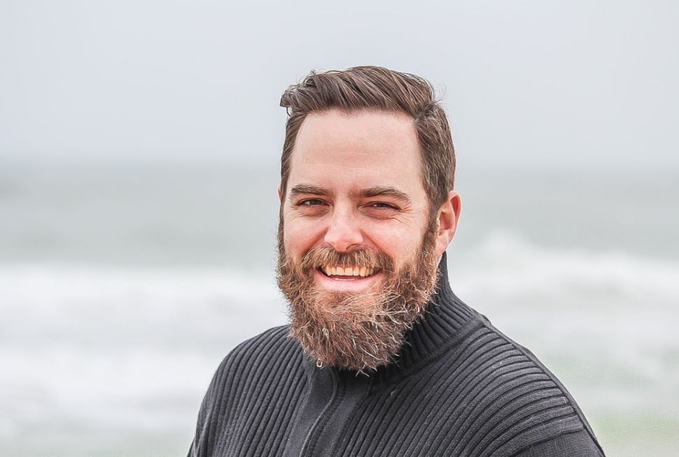 happy smiling man by the sea with a beard