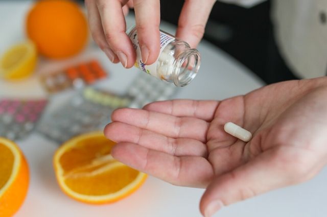 person holding a fat burner pill