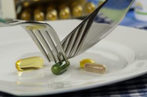 capsules on plate with a knife and fork